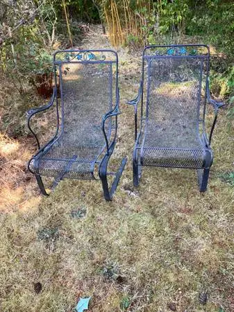 A pair of comfortable iron garden chairs