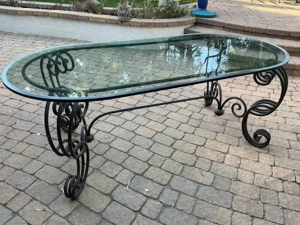 Great glass oval table with wrought Iron base hand crafted