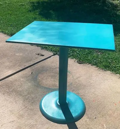 Steel table with cast iron base and gray stone top