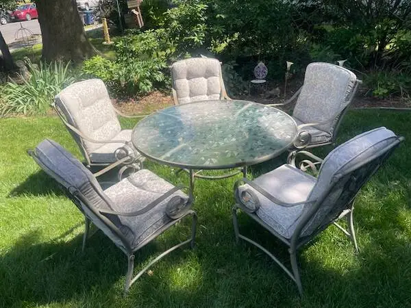 Vintage gray cast steel 54” round glass top patio table and 5 chairs