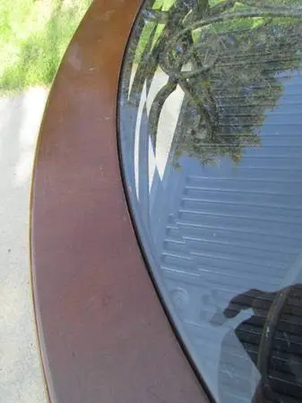 Vintage round coffee table with wrought iron base and glass top