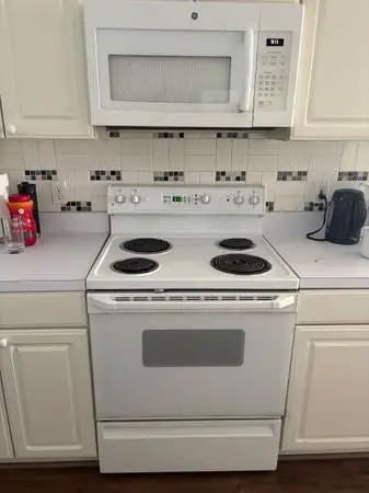 White stove with four electric burners
