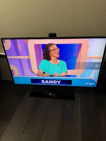 Samsung Smart TV with remote, streaming apps, and Vizio Bluetooth soundbar