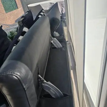 Black leather large 2 seater reclining sofa
