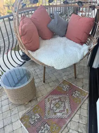 Large egg chair, coffee table, and rug