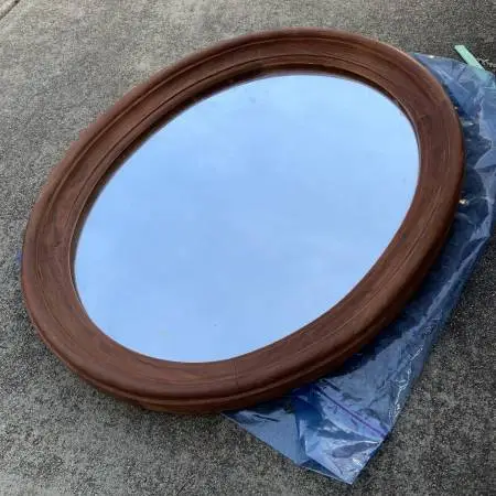 Vintage wood-framed oval mirror