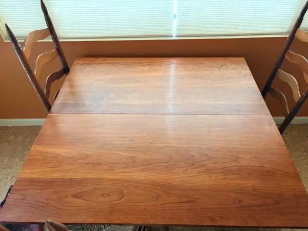 Maple Drop leaf Table, golden brown with 6 cane bottom chairs.