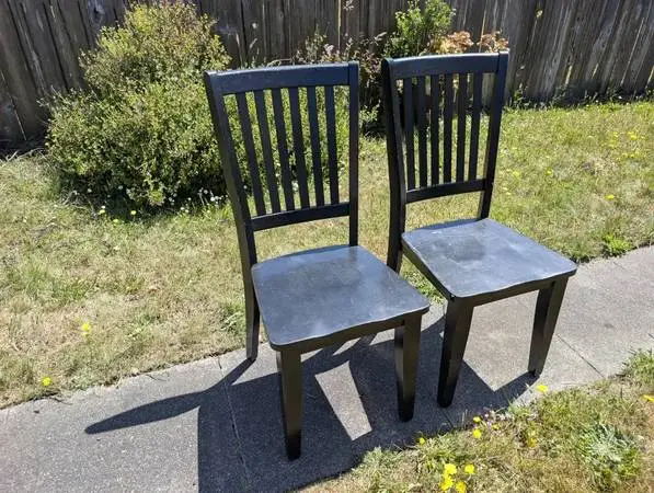 Two black solid wood teak chairs for sale