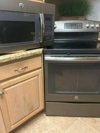 Black stainless steel GE stove and microwave