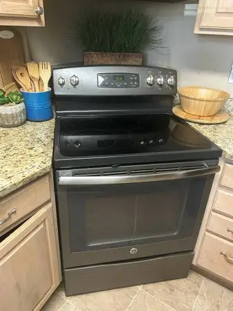 GE electric black, stainless stove and microwave