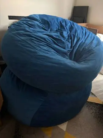 Two very large blue bean bag chairs