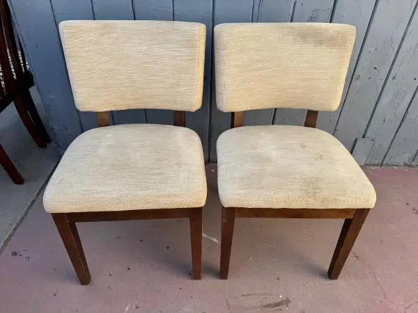 Two regular Vintage upholstered chairs. The chairs have wooden frames