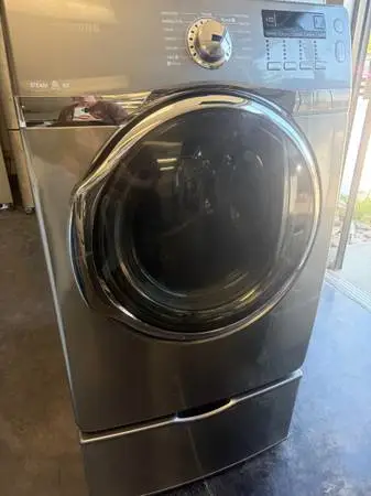 Steam Charcoal Grey Front Load Samsung Dryer on Pedestal