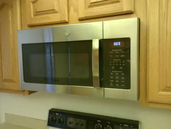 Built in stainless steel GE microwave with mounting bracket and screws