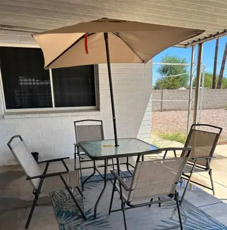 patio table umbrella, and four chairs patio rug $90 Set is brand new