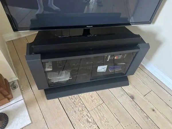 Black TV table with glass doors.
