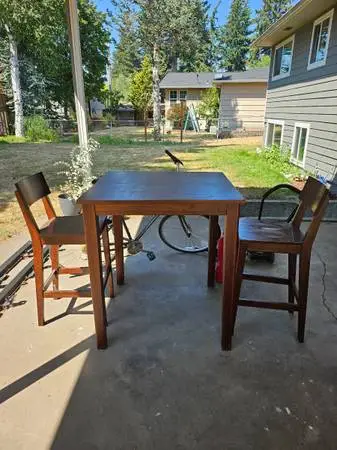 Table and 2 chairs solid wood decent condition at my yard sale