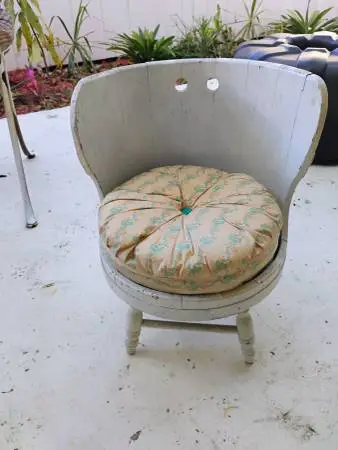 Antique wooden doll chair with pillow