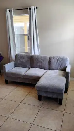 Newer smaller gray corduroy sofa with movable ottoman