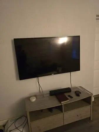 TV with surround sound speakers and dresser