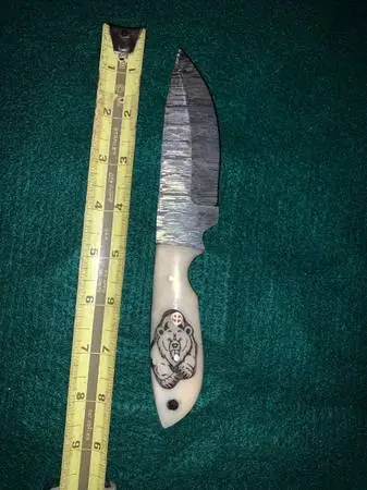 Damascus knife with bear on handle