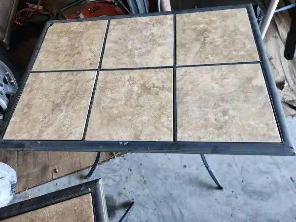 Two outdoor aluminum and tile patio tables available