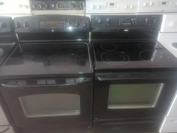 Several black gas top stoves
