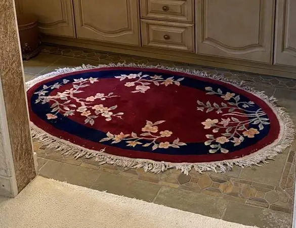 Add  charm to your home with this hand tufted oval wool rug