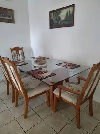 Glass and oak dining room table with 6 chairs