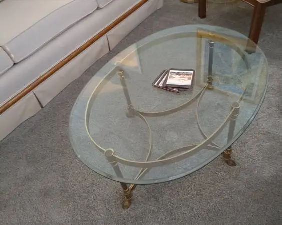 Oval shaped glass and brass coffee table