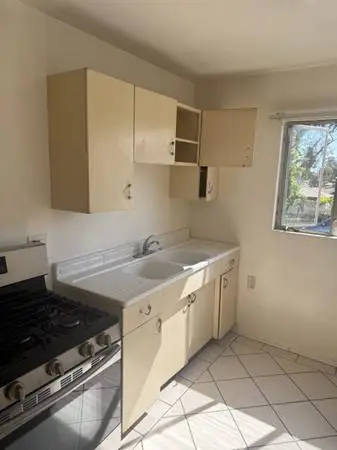 Kitchen Cabinets with counter top and faucet