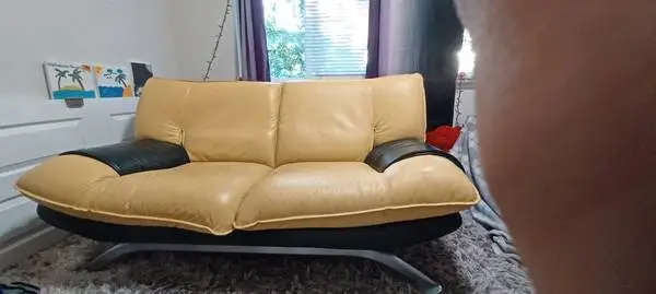 Yellow/ tan love seat . Leather