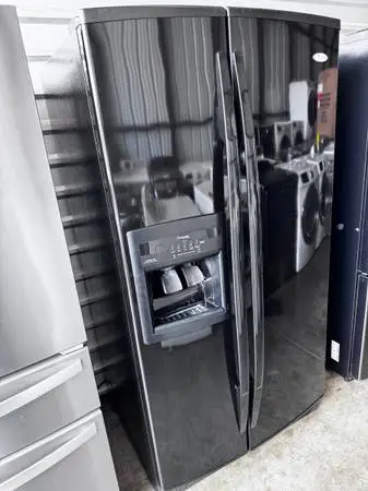 Black smooth whirlpool refrigerator side by side with water and ice di