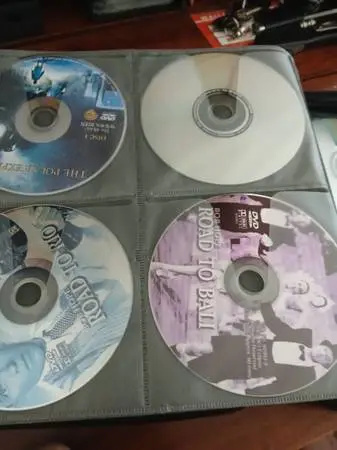 OVER 100 DVDS and CDS in CASE