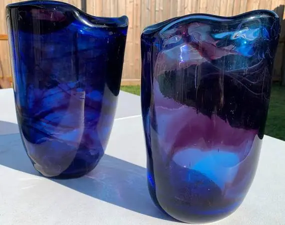 A pair of heavy duty glass vases