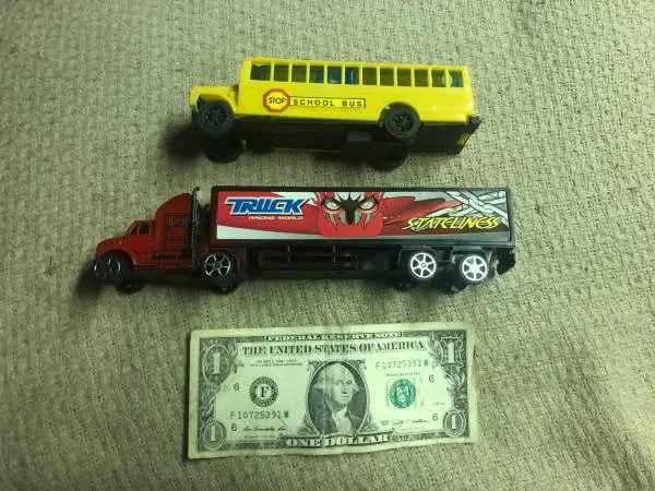Kids yellow school bus and semi truck trailer