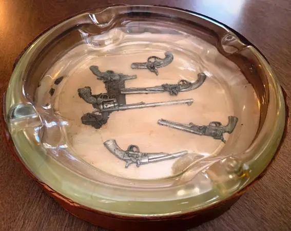 Antique cigar glass ash tray with pistol theme
