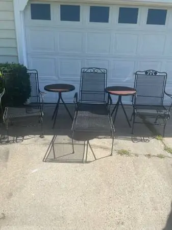 Two wrought iron rocker chairs and lounger chair and 2 tables