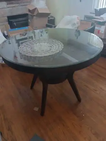 48 in round wood table by 36 in tall counter height with glass top