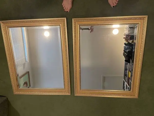 Two gold-tone framed wall mirrors