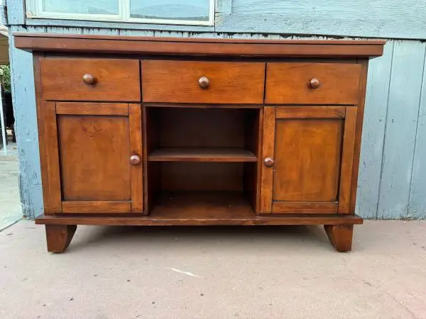 Solid wood sideboard in a warm brown finish with three top drawers, tw