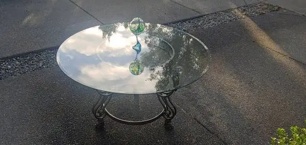 Circular Glass Table on a Bronze Base