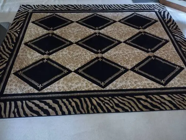 Black and yellow animal print area carpet like new 7 ft x 10 ft