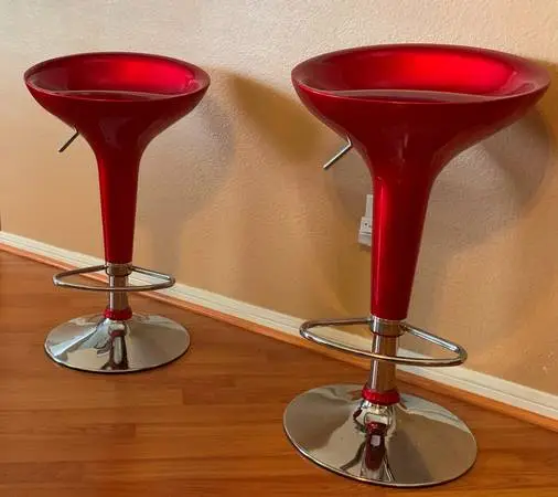 A set of two red adjustable swivel barstool, comtepory style