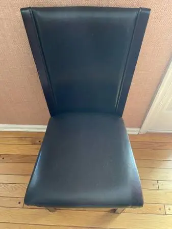 Chairs black with padded faux leather seats and backs