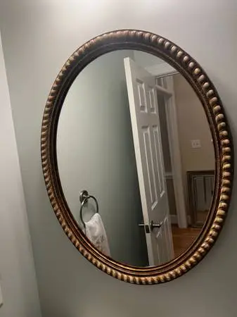 Ornate wood frame oval mirror