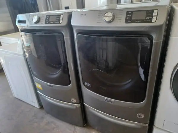 Maytag Grey Front Load Washer/Electric Dryer Set On Pedestals