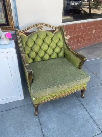 Antique vintage green gold tufted chair has some tears