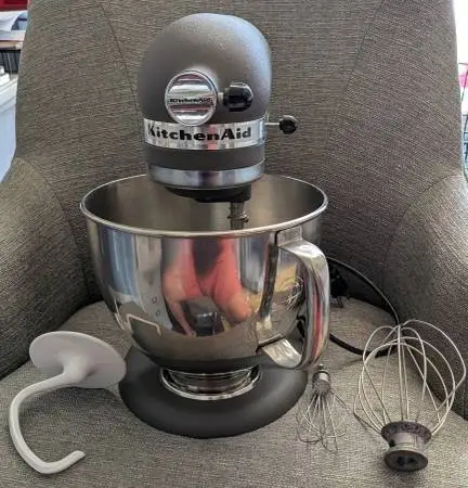 Grey KitchenAid Artisan 5 Qt stand mixer with bowl, tools