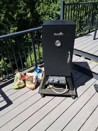 Natural Gas smoker on base with wheels.